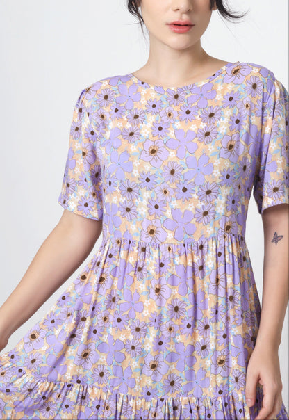 Woman wearing a purple floral dress on a white background